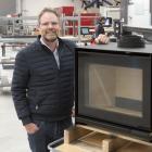 Escea Fireplace Company chief executive Nigel Bamford showcases the company’s new woodburner in...