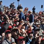Some of the 70,000 spectators track a USAF F-16 jet through the sky at Warbirds over Wanaka over...