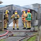 Fire and Emergency New Zealand crews mop up following a garage fire in Barton St, Brockville on...