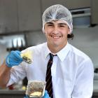 John McGlashan College year 12 pupil Lachie Sutherland, 16, places the potato on top of the...