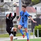 Dunedin City Royals player, Will Turner, engages in an aerial battle with Cashmere keeper Danny...