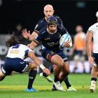 Highlanders skipper Billy Harmon has fellow loose forward Hugh Renton in support as he challenges...