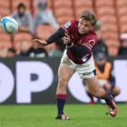 Highlanders halfback James Arscott sends out a pass during the game against the Chiefs in...