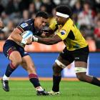 Ajay Faleafaga of the Highlanders runs into Hurricanes defence during their recent clash in...