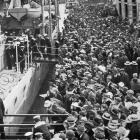 A crowd on the Rattray St wharf following the berthing of British light cruiser HMS Dunedin, soon...
