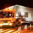 A 9m-wide transportable home built by Big River Homes takes up all the road as it is hauled...
