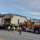 King House Removals staff wait on the side of the road near Queenstown to let traffic past late...