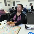 Olivia En takes part in a National Scrabble Day tournament in South Dunedin on Sunday. PHOTO:...