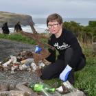 Dunedin volunteer Tracy MacAulay-Higgan holds up a rusted windscreen wiper found during the clean...