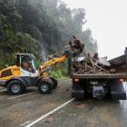 Crews clearing a slip on State Highway 6 near Franz Josef. Photo: RNZ