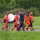 Medical personnel carry Slovakia's Prime Minister Robert Fico to hospital after being transported...
