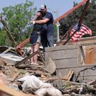 Phillip and Kimberly Ergish embrace amongst the remnants of their Greenfield home. Kimberly took...