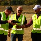Watched by Gibbston Valley Resort CEO Greg Hunt, Sir John Key, left, pours bubbles for his son...