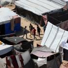 Displaced Palestinian boys play football as they shelter at a tent camp, amid the ongoing...
