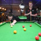 Jackson Wright (left) plays a shot while Blane Watson watches on at Bowey’s Pool Lounge in...