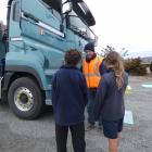 Alexandra Primary School pupils watch as Share the Road educator Kelvin Aris demonstrates how far...