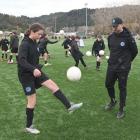Dunedin City Royals Academy director-coach Blair Scoullar watches Charlotte Evans, 11, as she...