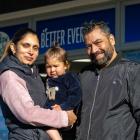 Thames Discounter and Takeaways owners Tania and Sunny Bal with daughter Grace, 2, outside the...