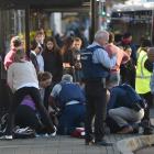 Emergency services attend to the teenager at the Dunedin bus hub yesterday. PHOTO: GREGOR RICHARDSON