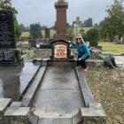 Christine Chisholm poses beside the graves of her great-grandparents Creighton Reid and Sarah...