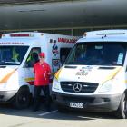 Pro Med team member Brian Green between the two ambulances in operation for the company in...