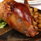 A roast baby pig served with potatoes. Photo: Getty Images