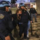 New York Police Department officers enter the Columbia University building and detain pro...