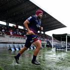 Highlanders captain Billy Harmon runs on to the field during his team’s round 11 Super Rugby...