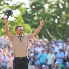 Xander Schauffele celebrates after holing his birdie putt on the 18th hole to claim his maiden...