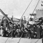 School children are shown an anti-aircraft gun on Royal Navy light cruiser HMS Dunedin. — Otago...