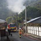 Smoke rises from a house fire in Karoro, south of Greymouth, this morning. Photo: Greymouth Star