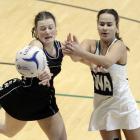 Southern Magpies centre Emma de Lautour (left) blocks a pass intended for Columba College wing...