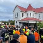 Miners and protesters wait for the meeting to start in Blackball yesterday. PHOTO: GREYMOUTH STAR
