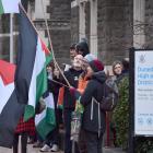 Pro-Palestine demonstrators stand outside the Dunedin District Court in support of a fellow...