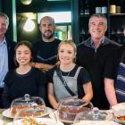 Standing behind the counter at Riverstone Kitchen are (from left) Mayor Gary Kircher, employee...