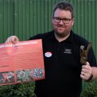 Woolworks New Zealand South Island innovation manager Mitchell Young holds a sign on ways to...