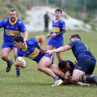 Hame Toma (centre )and Hunter Fahey (right) for Dunedin try to slow down Josh Whaanga (left) for...