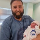 Wyndham rugby player Brad Shaw and baby Marlee fly the flag shortly after her birth at Southland...