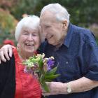 Jack Stanley, 87, gives his wife Joan, 86, flowers (without a paper bag) to celebrate their 65th...