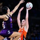Giants goal attack Sophie Dwyer lines up a super shot under the pressure 
...