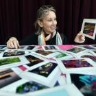 A visitor off a cruise ship looks through cards at the Port Chalmers Artisan Markets earlier this...