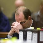 Murder accused David Bain sits with his head down yesterday in the High Court at Christchurch.