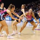 Steel captain Kate Heffernan feeds the ball to shooter Grace Namana under the pressure of Magic...