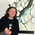 Writer and multimedia artist Pam McKinlay poses with her lightbox artwork A River Runs Through Me...