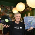 Avid record collector Scott Muir holds some of the items he had for sale at a records and Kiwiana...