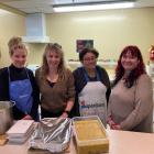Departing SuperGrans manager Sandy McKay (second from left) gathers with regular Monday cooking...