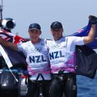 Isaac McHardie and Will McKenzie celebrate after winning silver in the men's 49er skiff. Photo:...