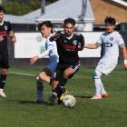 Coastal Spirit’s Matt Bergin beats a pair of Christchurch United defenders during his team’s 1-0...