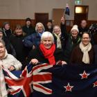 Val Butcher (centre) leads a group of Ophir residents cheering on her grandson Finn Butcher, who...
