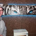 Recycled snowboard exhibition organiser Jase John with a white tiger painted on a board by...